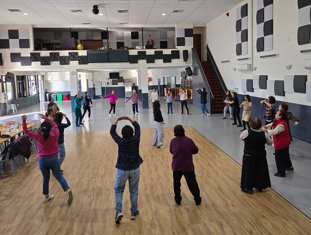 A wellbeing group doing exercises being held at the CAASSA community centre.