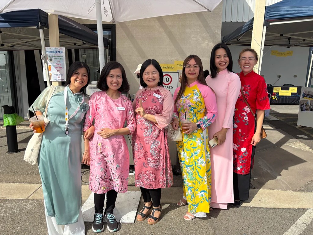 A group of women in traditional Vietnamese attire at the friendship cafe.
